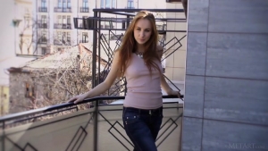 Young lady gets comfortable on the balcony